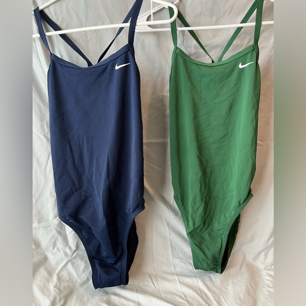 Two Nike practice suits